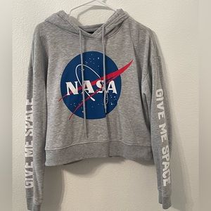 A Nasa hoodie with “ give me space” lettered on the side